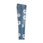 Light blue straight-leg jeans with white floral pattern, side view on white background.