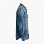 Side view of a medium-wash denim shirt buttoned up with long cuffed sleeves and a single chest pocket on the right side, displayed on a white background.