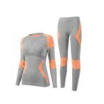 Orange women’s seamless ski base layer set with long-sleeve top and leggings, front view on a white background.