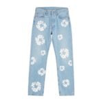 Sky blue denim jeans with white floral print laid flat on white background.