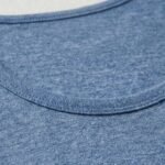 Close-up view of a woman wearing a fitted athletic tank top, highlighting neckline, straps, and fabric texture