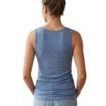 Back view of a woman wearing a fitted athletic tank top and leggings, showing strap design and upper-back coverage