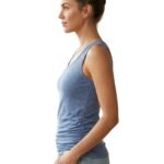 Side view of a woman wearing a fitted athletic tank top and leggings, showing armhole, side seam, and overall silhouette