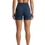 Woman wearing black gym shorts, back view.