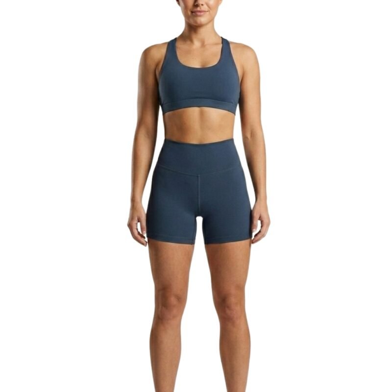 Woman wearing black gym shorts, front view.