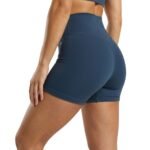 Woman wearing black gym shorts, side view.