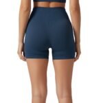 Back view of a woman wearing high-waisted black yoga shorts and sports bra, showing waistband and coverage