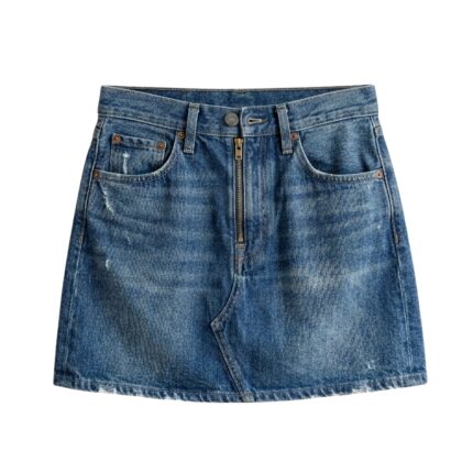 Studio shot of custom medium-wash denim mini skirt with front zipper and distressed vintage aesthetic, manufactured by Eco Jersey Limited