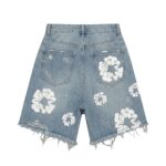 Back view of light blue distressed denim shorts with frayed hem and ripped detailing.