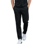 Male model wearing basketball sweatpants, showing a relaxed straight-leg fit, elastic waistband, and small logo icon near the upper leg.