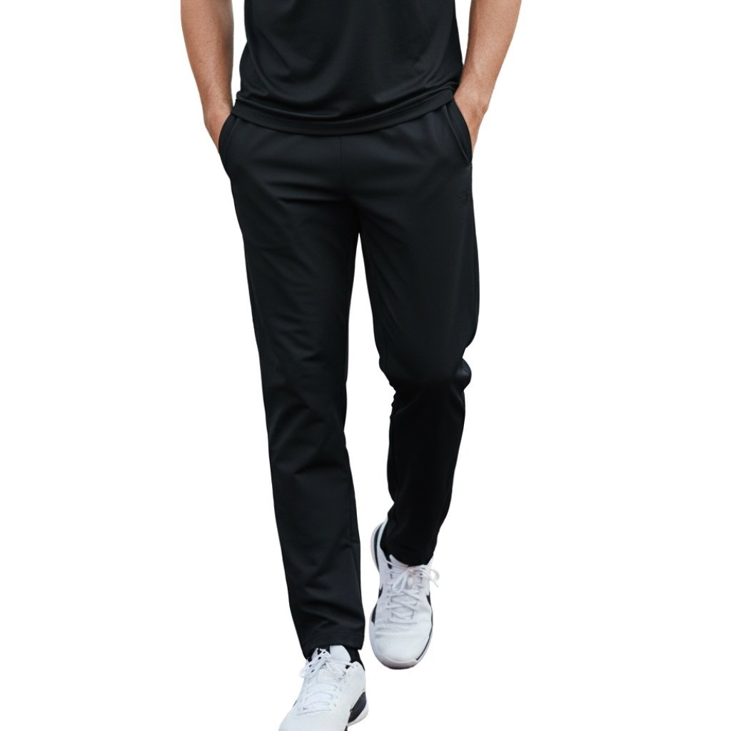 Male model wearing basketball sweatpants, showing a relaxed straight-leg fit, elastic waistband, and small logo icon near the upper leg.