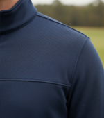 Close‑up of the men’s quarter‑zip performance pullover fabric, showing smooth, technical knit texture and stitching detail.