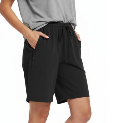 Woman wearing hiking cargo golf shorts and a casual top, standing in a relaxed pose to show the mid‑thigh length, waistband, and functional pockets in stretch quick‑dry fabric