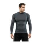 Male model wearing an ice hockey base layer compression set, standing in a relaxed pose to show the athletic fit of the top and leggings