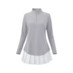 Front view of a women’s gray quarter‑zip long sleeve golf dress on a model, featuring a stand collar, fitted long sleeves, and an above‑the‑knee athletic silhouette in soft gray performance fabric.