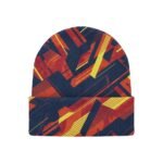 A navy blue beanie hat with a folded brim, featuring bold orange and yellow geometric pattern shapes on a white background.