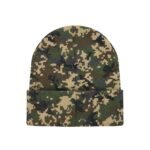 A knit beanie hat featuring a digital camouflage pattern in green, brown, beige, and black against a white background.
