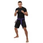 Martial artist wearing an MMA cotton Jiu Jitsu rank belt tied around the gi, showing how the belt fits in use.