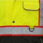 Close-up of durable blue workwear jacket fabric, showing texture, seams, and reinforced stitching.