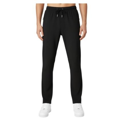 Male model wearing men’s badminton pants in lightweight performance fabric, standing on a plain background with a small logo icon near the pocket.