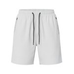 Front view of men’s badminton shorts made from lightweight performance fabric, laid flat on a plain background with a small logo icon near the hem.