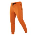 Front view of men’s rugby joggers in orange with elastic waistband, drawstring, tapered legs, ankle cuffs, and small logo icon near the pocket, displayed on a plain background.