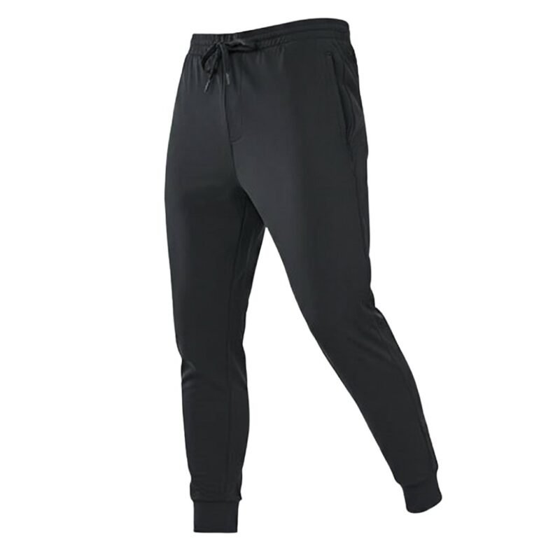 Front view of men’s rugby joggers in dark color with elastic waistband, drawstring, tapered legs, and ankle cuffs, displayed on a plain background.
