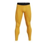 Mustard yellow men’s tennis leggings, front view, showing full-length compression fit, wide waistband, and small logo icon near the hip.
