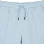 Close-up front view of men’s tennis shorts waistband, showing elastic band, drawstring, and smooth quick-dry fabric.
