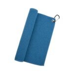 Gray microfiber golf towel laid flat, featuring a soft textured surface, stitched edges, and a small white logo icon in one corner next to the metal grommet and carabiner for attaching to a golf bag