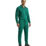 Pigment green men’s polo tracksuit laid out in a clean studio view