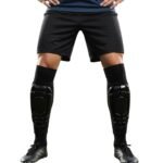 Model wearing custom soccer shinguard sleeves that feature a bold sublimated graphic design and snug, compression-style fit.