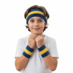 Person wearing a matching set of terry cloth tennis sweatbands, including a headband and wristbands, in an athletic pose.