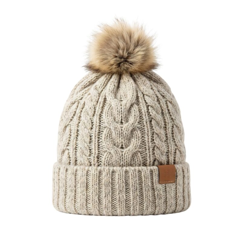 Cream-colored winter beanie hat displayed on a plain background.
