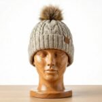 Front view of a winter beanie hat displayed on a plain background.