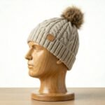 Model wearing a winter beanie in a cold-weather outdoor setting.