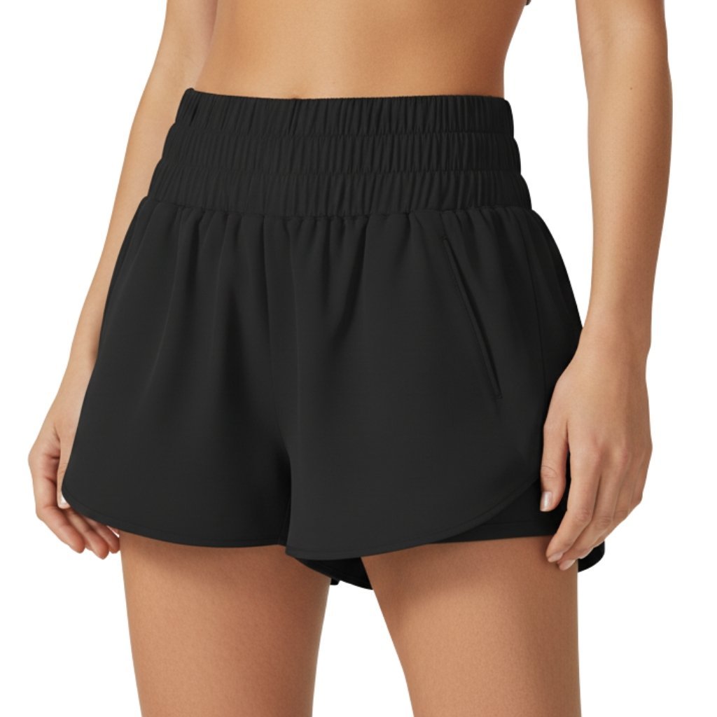 Female model wearing women’s badminton shorts made from lightweight quick-dry fabric, standing against a plain background with a small logo icon near the hem.