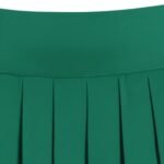 Close-up of a women’s light gray golf skort, showing the smooth waistband, front panel, and small logo icon near the hem