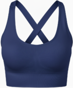 Light gray women’s golf sports bra shown from the front on a model. Scoop neck, wide straps, smooth breathable fabric, and a small logo icon on the band.