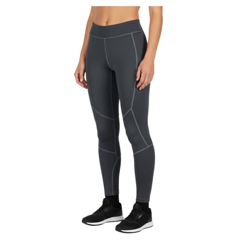 Model wearing women’s ice hockey compression pants, standing to show the high waistband, full-length slim legs, and supportive athletic fit.