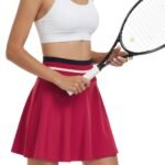 Model wearing women’s high performance tennis skort and top, shown from the front in a relaxed stance to highlight the flat waistband, athletic length, and comfortable on‑court fit.