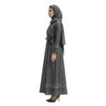 Side view of woman wearing a black abaya, full-length modest dress