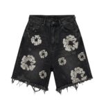 Black distressed denim shorts with frayed hem and ripped detailing on the front.