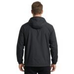 Man wearing a camping jacket, side view on a plain background.