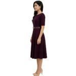 Female model wearing a casual dress, side view on a plain background.