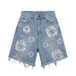 Light blue distressed denim shorts with heavy ripped detailing and frayed hem.