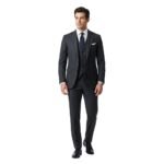 Male model wearing a black three‑piece suit with black tie, front view on a plain background.