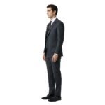 Male model in a black three‑piece suit with black tie, side view pose against a plain background.