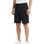 Model wearing men’s soccer shorts, standing to show the mid-rise elastic waistband, relaxed athletic fit, and bold logo icon on the leg.