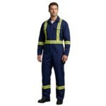Male model wearing men’s navy industrial coveralls, standing in a relaxed pose.